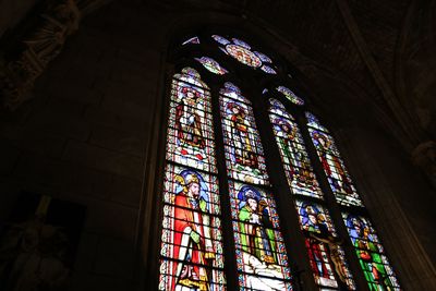 Low angle view of stained glass window in building