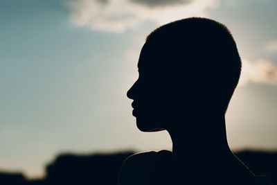 Close-up portrait of silhouette man against sky during sunset
