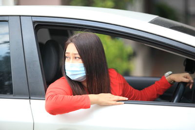 Portrait of woman sitting in car