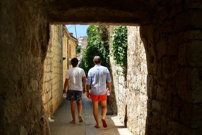 Rear view of people walking in ancient city