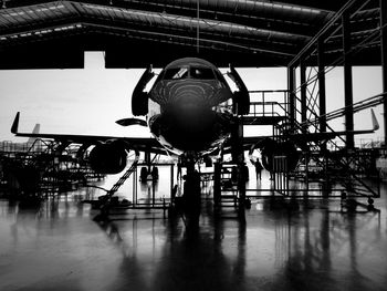 Airplane in airport against clear sky