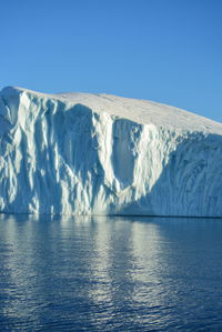 Scenic view of frozen sea against clear blue sky