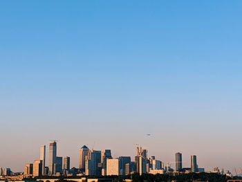 Modern buildings against clear blue sky