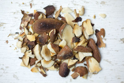 High angle close-up of nuts on old wooden table