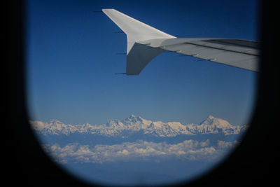 Close-up of airplane wing against clear blue sky