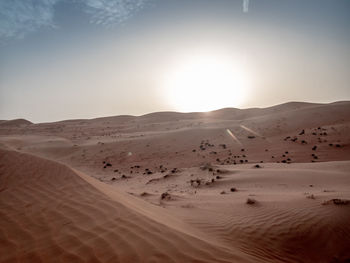 Scenic view of desert against sky during sunset