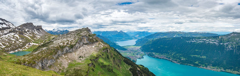 Scenic view of sea and mountains against sky