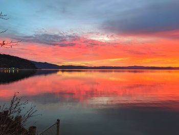 Scenic view of lake against romantic sky at sunset