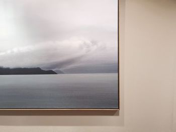 Scenic view of sea against sky seen through window