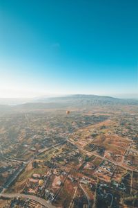 Aerial view of townscape against clear blue sky