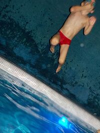 Low section of woman swimming in pool