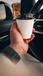 Cropped hand of man holding coffee