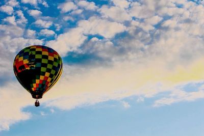 Low angle view of hot air balloons against blue sky