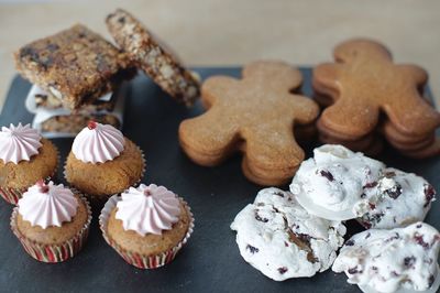 High angle view of cupcakes and cookies on table