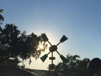 Low angle view of communications tower against sky during sunset