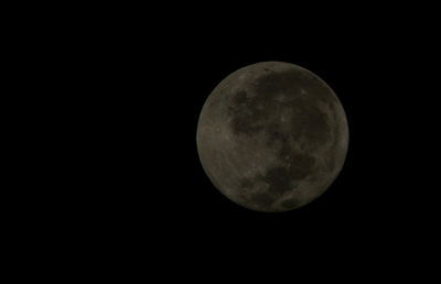 Low angle view of moon against clear sky at night