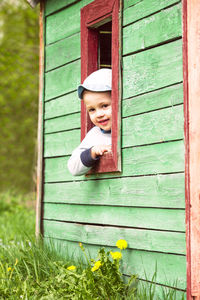 Portrait of cute boy in front door