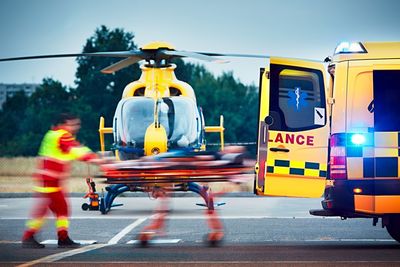 View of paramedics and ambulance by helicopter