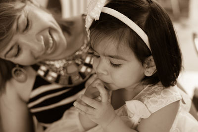 Close-up of girl held by a woman