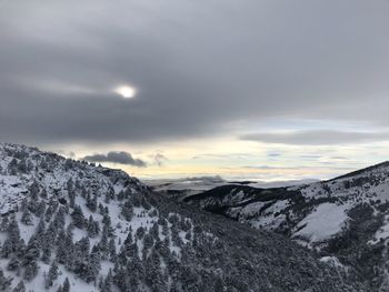 Scenic view of snow covered mountains against sky