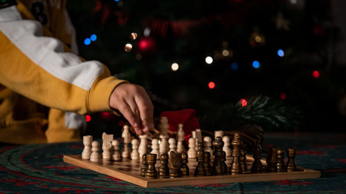 Midsection of child playing with chess in christmas time