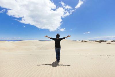 Full length of man standing on land against sky