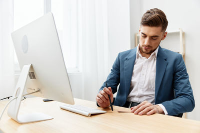 Young man working at desk in office