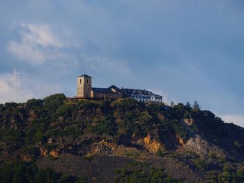 Low angle view of historic building on mountain against sky