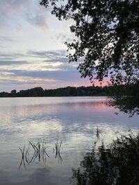 Scenic view of lake against sky at sunset