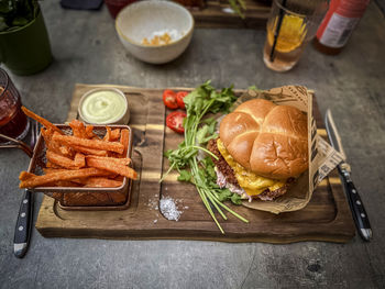 A good looking fantastic burger with sweet potatoes on table