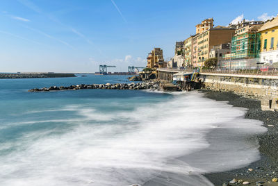 Scenic view of sea against sky in city