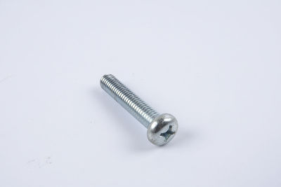 Close-up of screw on gray background