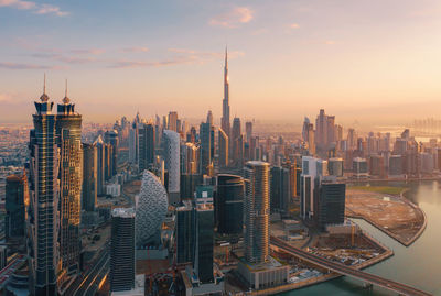 Aerial view of buildings in city during sunset