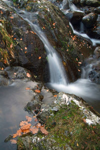 Scenic view of river flowing through rocks