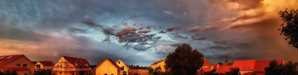 Low angle view of buildings against sky during sunset