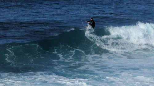 Person surfing in sea