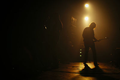 Silhouette of woman in dark room