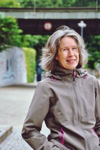 Portrait of smiling mature woman standing outdoors