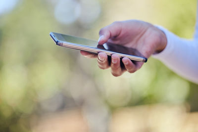 Midsection of woman using mobile phone