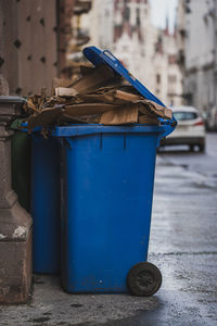 Garbage can on street in city