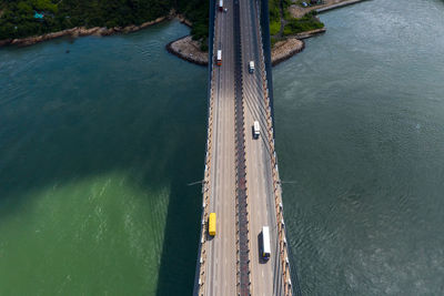 Drone view of vehicles on bridge over sea