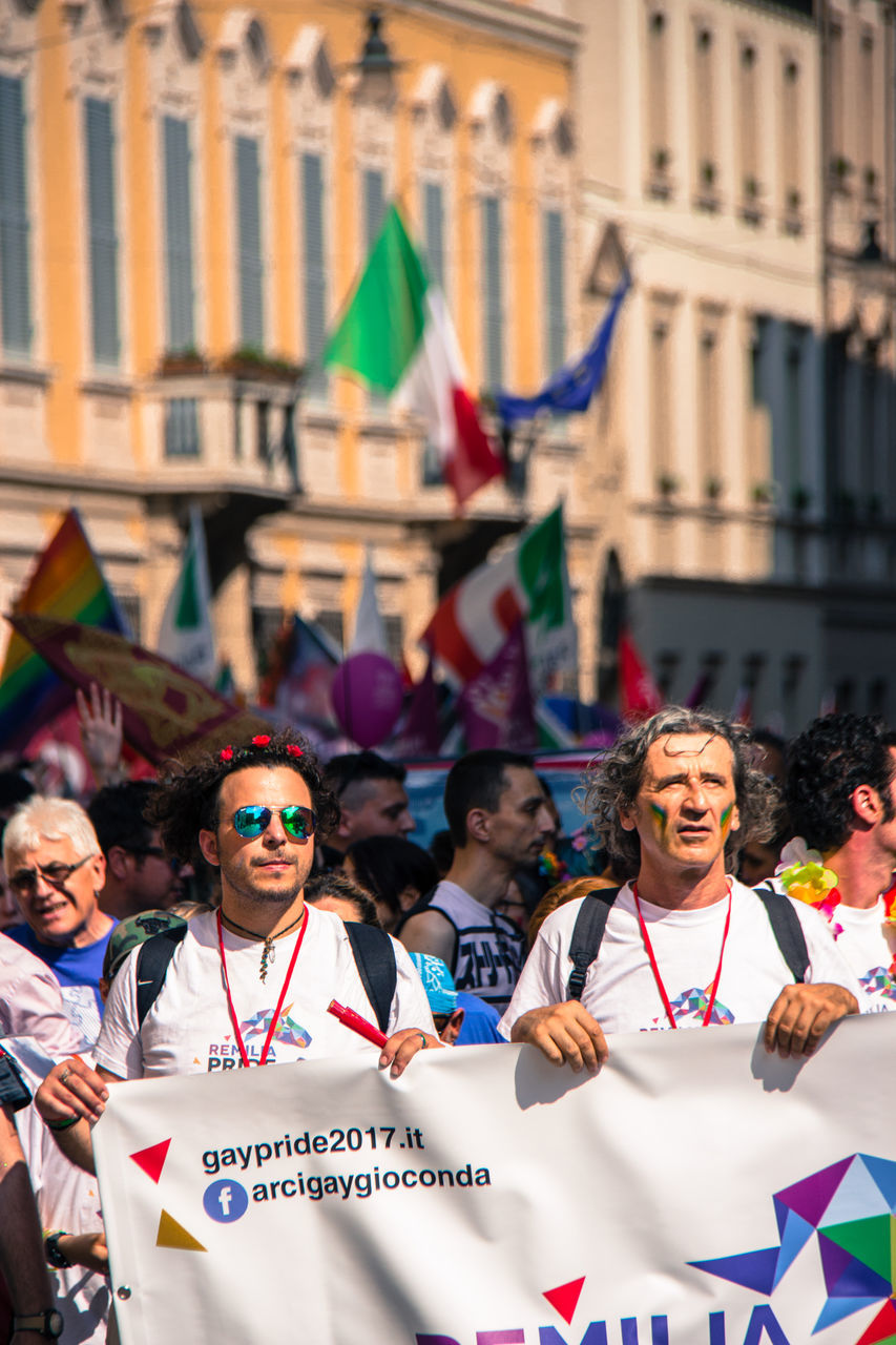 real people, protest, men, flag, event, celebration, patriotism, architecture, protestor, day, togetherness, looking at camera, portrait, women, politics, outdoors, large group of people, building exterior, city, crowd, politics and government, adult, adults only, people