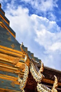 Low angle view of giraffe on building against sky