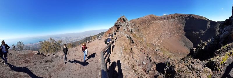 Panoramic view of rocks and mountains against blue sky