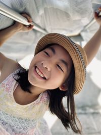 Portrait of young woman wearing hat at beach