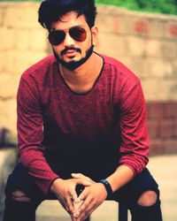 Close-up of young man sitting outdoors