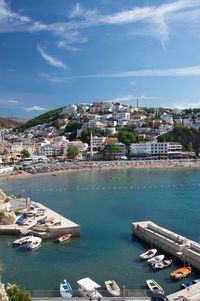 High angle view of townscape by sea against sky