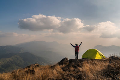 Man standing on mountain road against sky