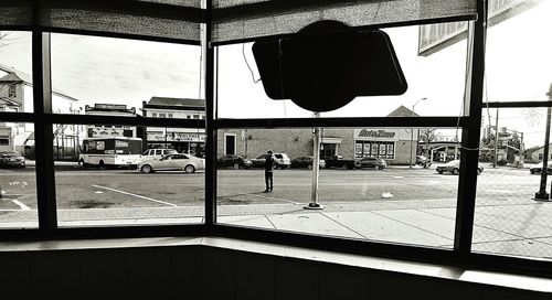 Man seen through window