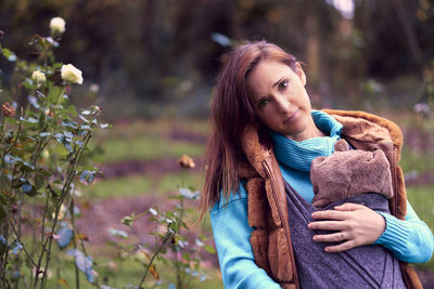 Portrait of woman against plants